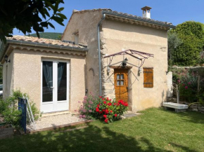 Cabanon entouré de montagnes et d'oliviers